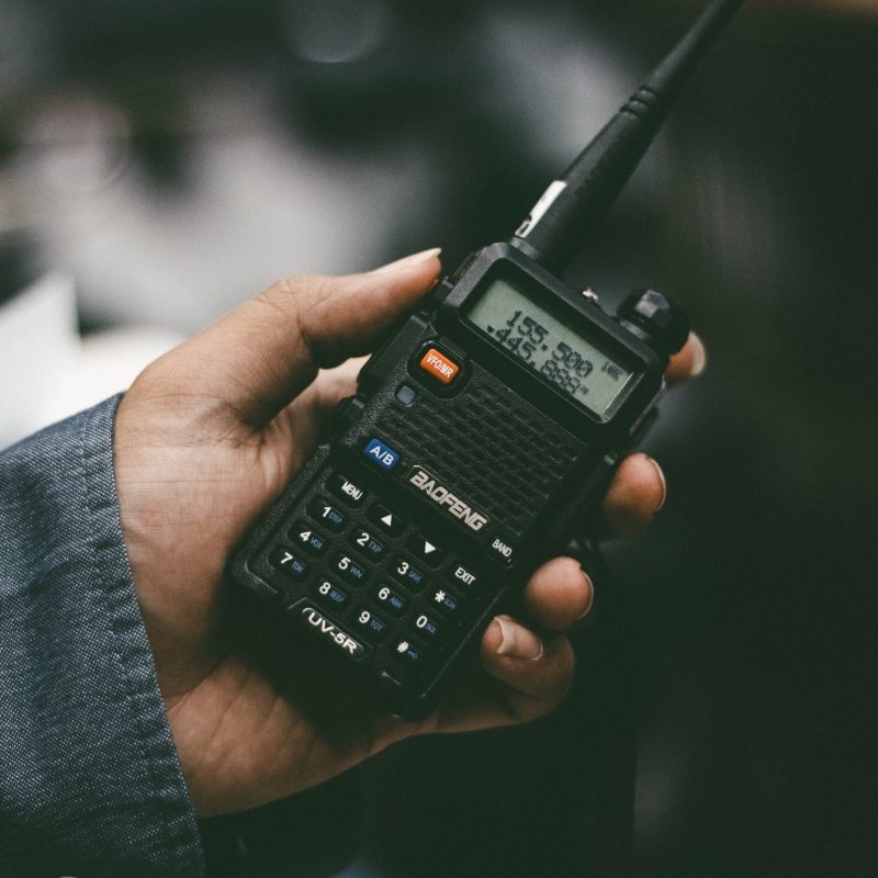 Camper holding walkie talkie