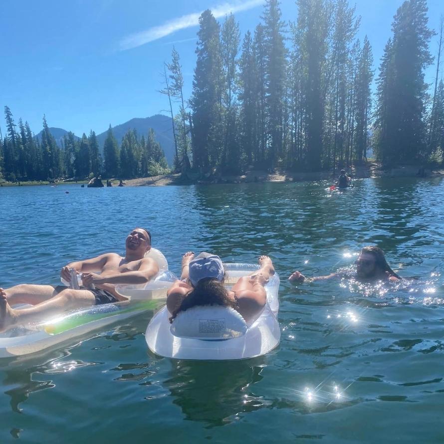 3 Campers swimming in a Lake